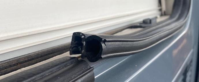 Rubber edge trim on the side of a panel